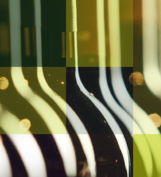  Close-up of wine bottles in soft lighting – Hogan Lovells Berlin case study on cross-border transactions and global consumer brands.