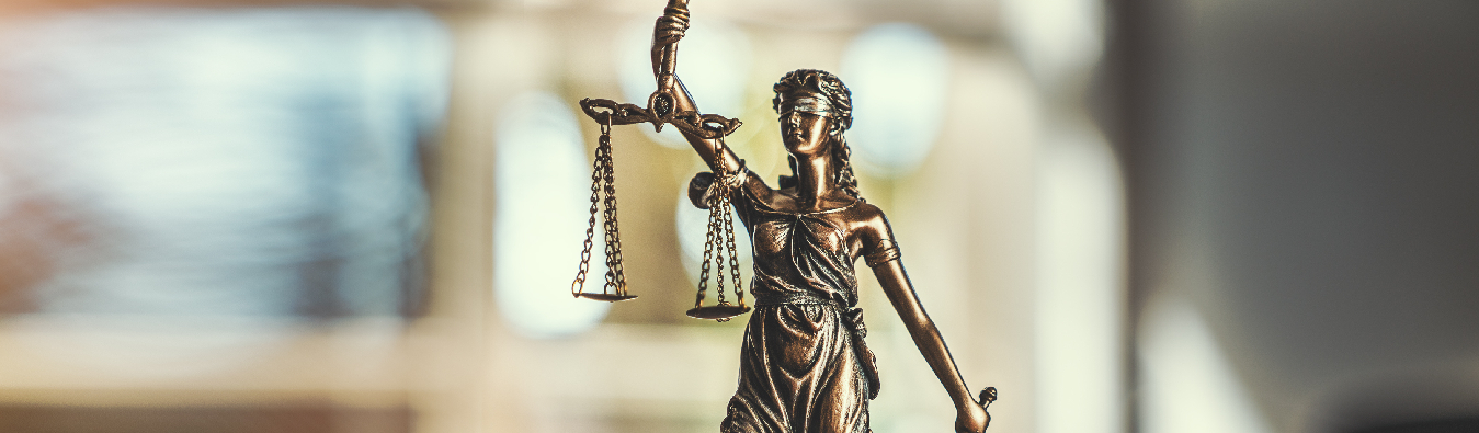  A statue of Justitia, the Roman goddess of Justice, wearing a blindfold for impartiality and holding scales to symbolize evidence weighing